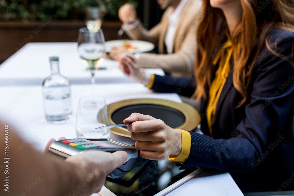 Woman paying with credit card in a restaurant Woman paying with credit card in a restaurant