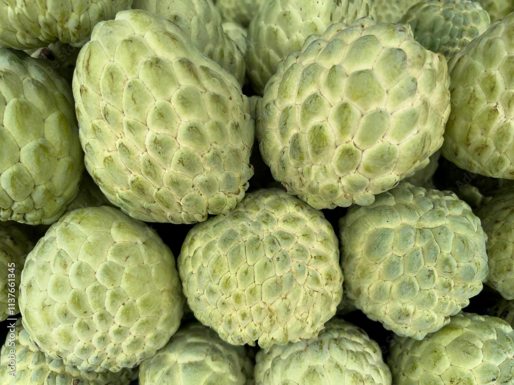 Close-up of fresh custard apples with textured skin. Close-up of fresh custard apples with textured skin.