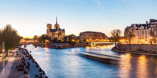 France, Paris, Tourist boat on Seine river with Notre Dame cathedral in background photo