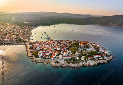 Obraz na płótnie Primosten, Croatia - Aerial view of Primosten peninsula and old town on a sunny summer morning in Dalmatia, Croatia. Blue and golden sky at sunrise on the Adriatic sea coast w salonie
