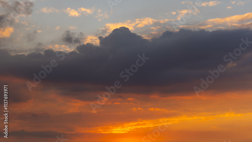 Beautiful sunset or sunrise sky, nature background. The beautiful clear sky was painted with bright golden shades by the sunlight.