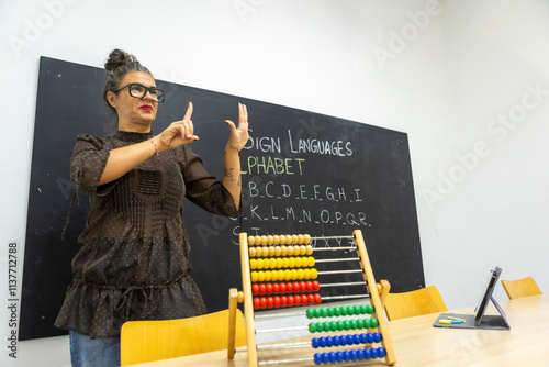 Teaching sign language, instructor demonstrating alphabet photo