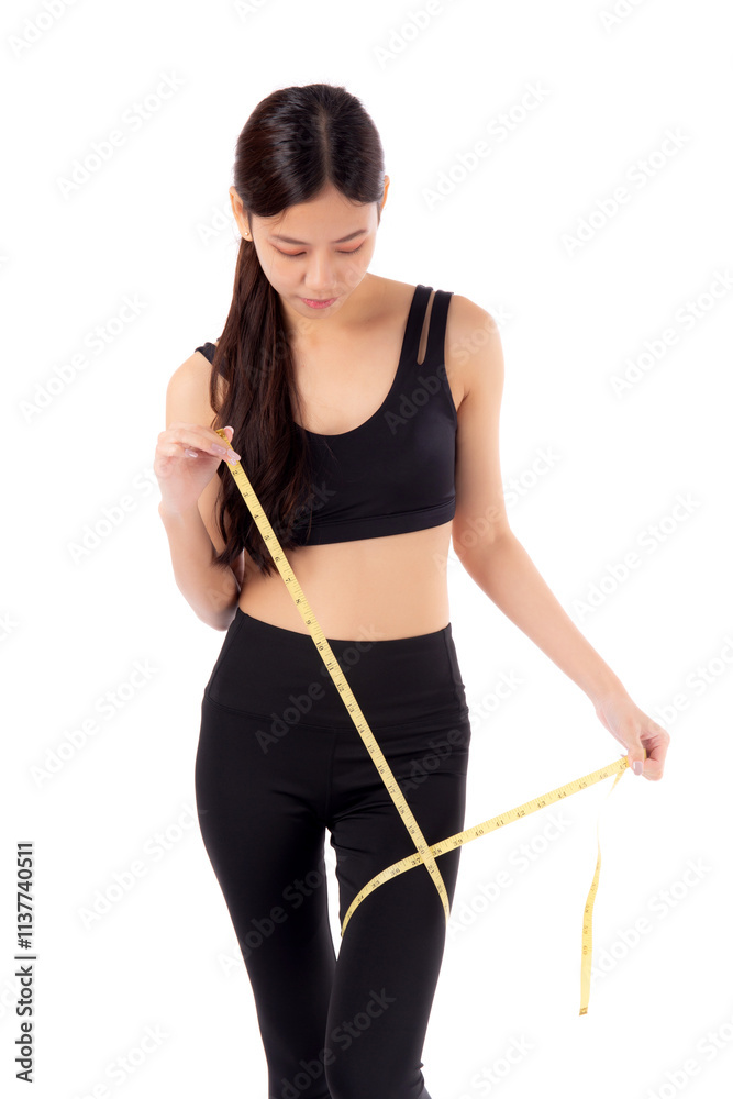 Portrait young asian woman in sportswear holding measuring tape leg for weight loss isolated white background, girl weightloss with workout and exercise while measurement with leg, sport and diet. Portrait young asian woman in sportswear holding measuring tape leg for weight loss isolated white background, girl weightloss with workout and exercise while measurement with leg, sport and diet.