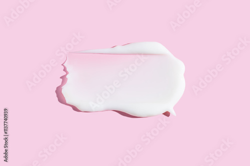 Creamy cosmetic texture smear on pink background photo