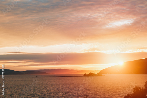 Scenic fjord sunset with vibrant orange sky