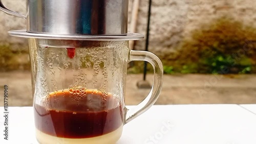 The barista serves coffee with a Vietnam drip coffee maker. Vietnam drip coffee.