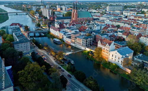 Cityscape of Odra river, bridges and big church with two towers in old town of city Opole Poland from drone