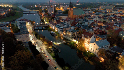 Night time view of river Odra with bridges in city Opole Poland from drone