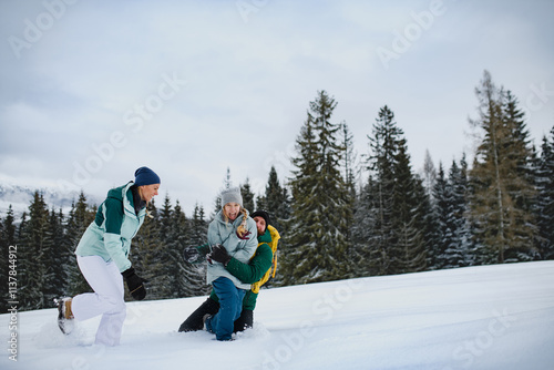 Family having fun in winter nature, playing in the snow. photo