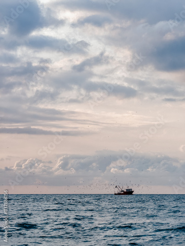 Fishing boat at dramatic sunset on Black Sea coast
