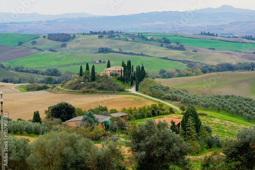 Tuscany rolling hills and farmhouse