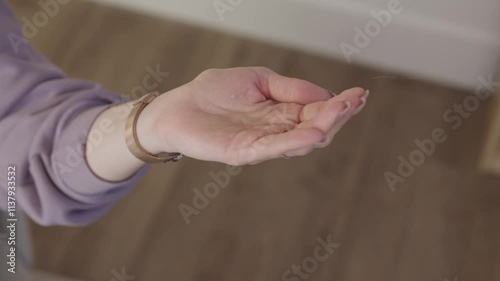 Hands Catch Dripping Water Drops Under Leaky Roof Inside Home. Rain Drips From Ceiling Damage Repair Roof and ceiling damage, home repairs. Homeownership challenges and renovations.