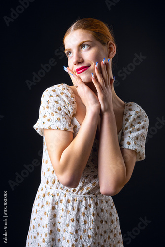 A young redhear girl with clean skin. Beauty portrait of a woman on a black background in the studio. photo