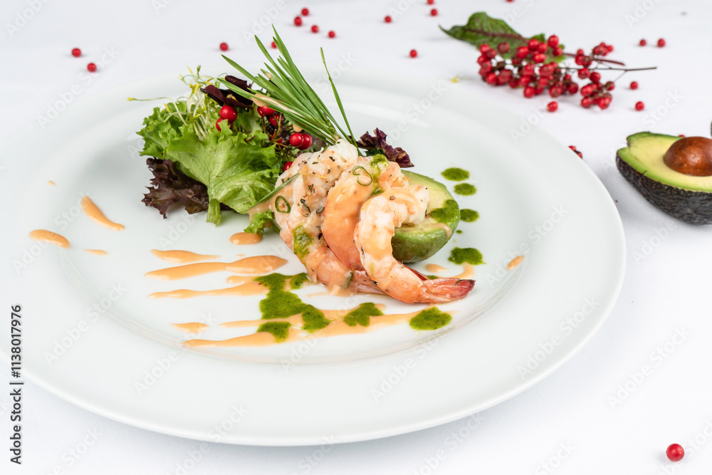 A delicious dish with tender shrimp, avocado and fresh greens. A healthy dinner. A delicious dish with tender shrimp, avocado and fresh greens. A healthy dinner.