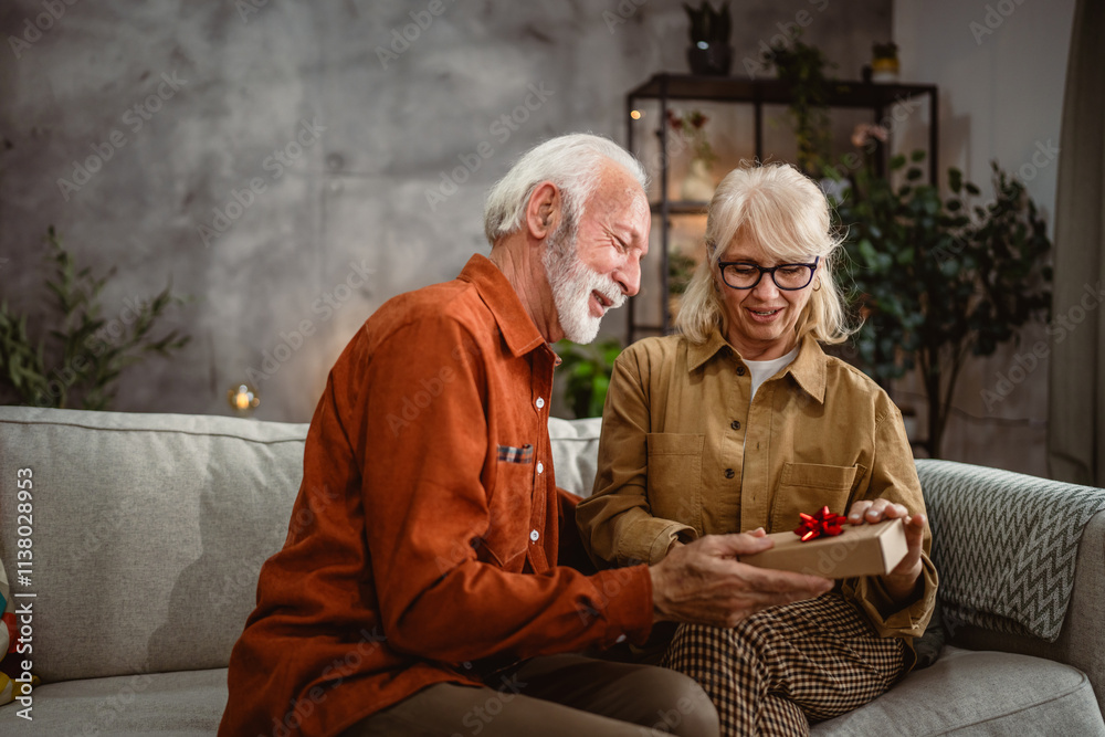 Senior husband surprise his senior wife with gift box while at home Senior husband surprise his senior wife with gift box while at home