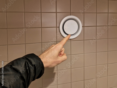 the ceiling of the corridor in plasterboard soffit is equipped with a circle of light. vapor and odor fan grill. regular cleaning ensures liquidation of mold spores with ozone photo