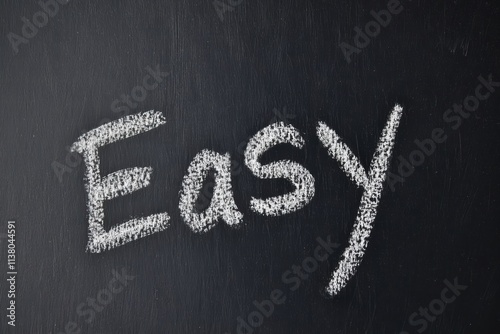 Blackboard with the word Easy written in chalk, symbolizing simplicity and straightforwardness in learning or tasks.