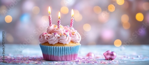 Festive cupcake with candles on a blurred background perfect for celebration greeting cards and birthday invitations