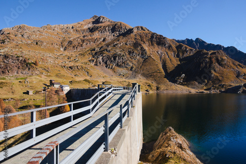 Walkway above the hydroelectric dam at lake Laghi Gemelli. In the background the Pizzo Farno and Monte Corte mountains. Orobie Alps, Lombardy, Italy photo