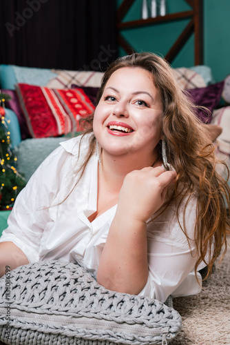 Fotografie A portrait of a beautiful,chubby  woman with a sweet smile against a New Year's backdrop