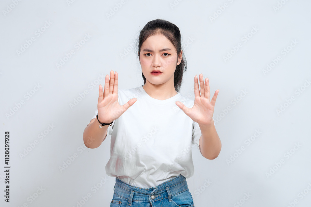 Stop. Concerned Asian woman showing refusal sign, saying no, raise awareness, standing over white background