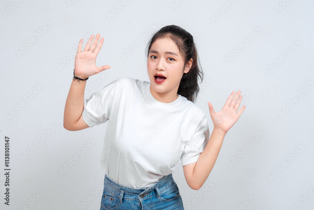 beautiful Asian woman with a surprised and excited expression, hands raised, and mouth open wide beautiful Asian woman with a surprised and excited expression, hands raised, and mouth open wide