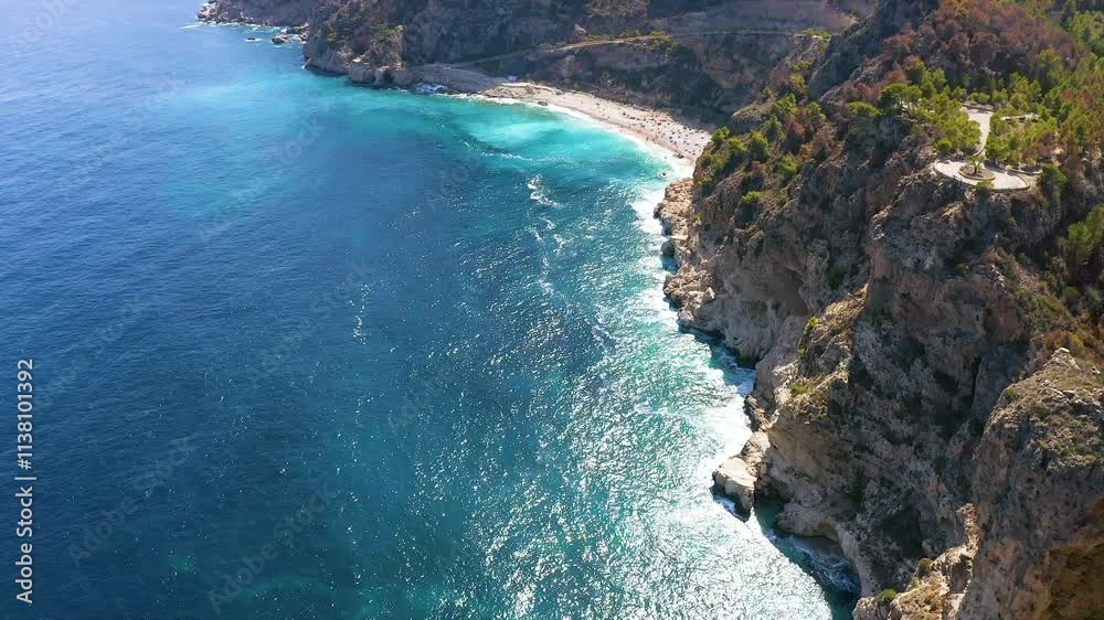 Aerial view of the wonderful Cala del Moraig and Cala de los Tiestos, located between the beautiful cliffs of the town of Benitachell, in the Mediterranean province of Alicante, Spain. Aerial view of the wonderful Cala del Moraig and Cala de los Tiestos, located between the beautiful cliffs of the town of Benitachell, in the Mediterranean province of Alicante, Spain.