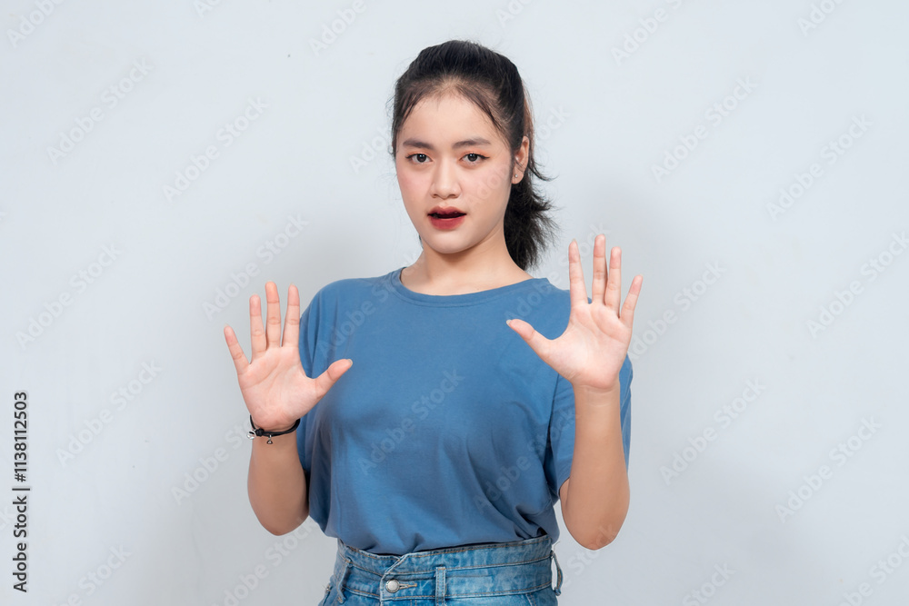 Stop. Concerned Asian woman showing refusal sign, saying no, raise awareness, standing over white background