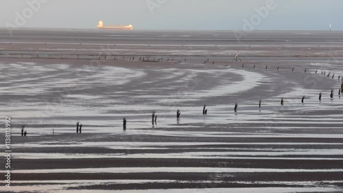 Wegmarkierungen durchs Wattenmeer bei Ebbe, Nordsee, Gezeiten, Wattwanderweg photo