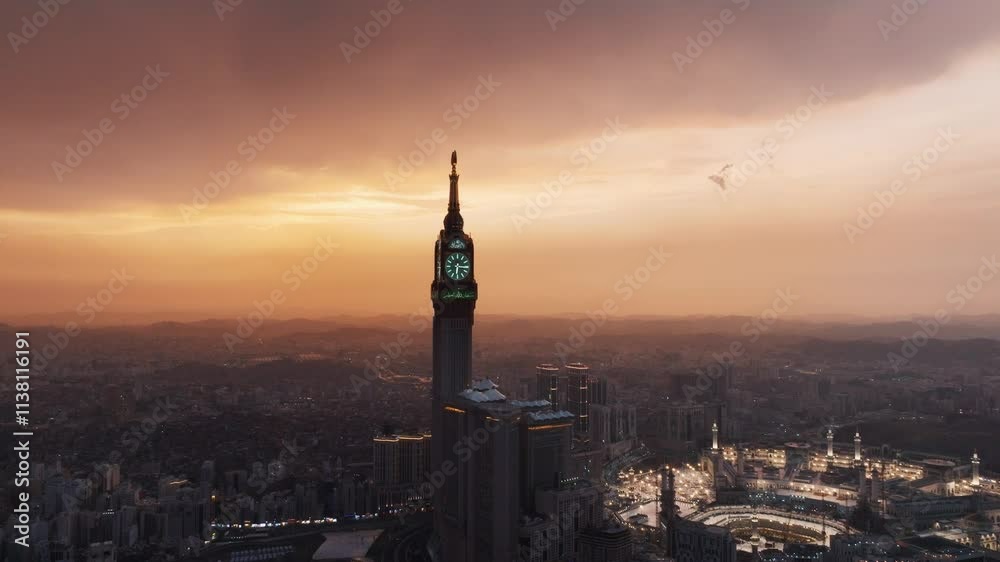 Aerial time lapse view showing crowds of pilgrims gathered around the Kaaba in the Grand Mosque, with construction cranes surrounding the site in Mecca