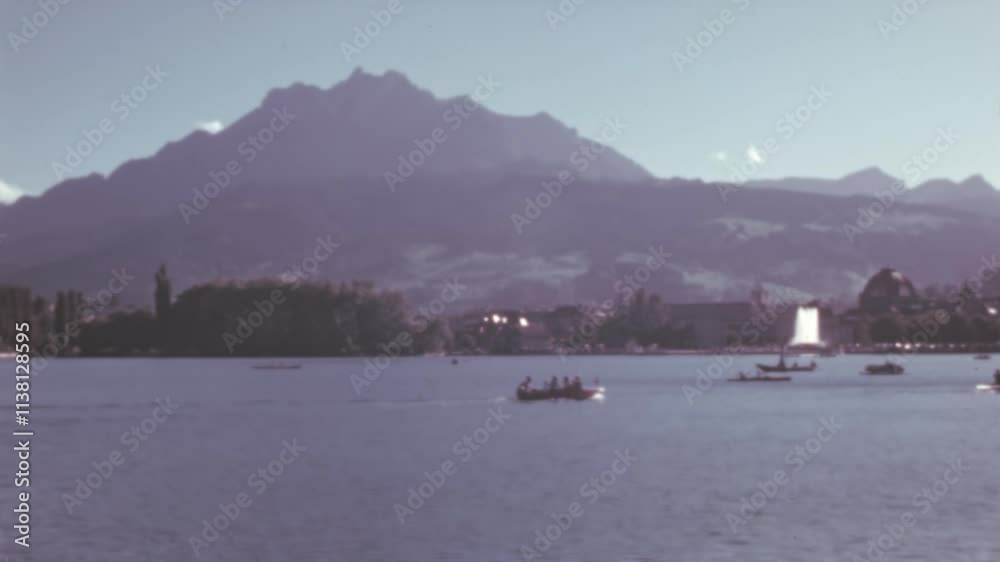 Serene view of Lake Lucerne with small boats on a sunny day, framed by the majestic Mount Rigi surrounded by three lakes: Lucerne, Zug, and Lauerz. Color 4K archival footage. Serene view of Lake Lucerne with small boats on a sunny day, framed by the majestic Mount Rigi surrounded by three lakes: Lucerne, Zug, and Lauerz. Color 4K archival footage.