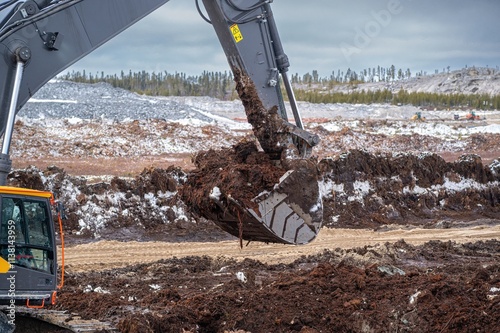 Excavator bucket filled with peat