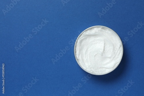 Jar of body cream on a color background
