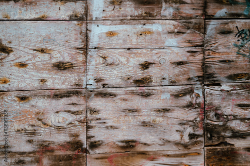 old wooden boards on the wall with black nail stains. used as a background