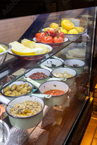 Artisanal delicatessen in Rome with fresh tomatoes, fruits, olives, and Italian delicacies