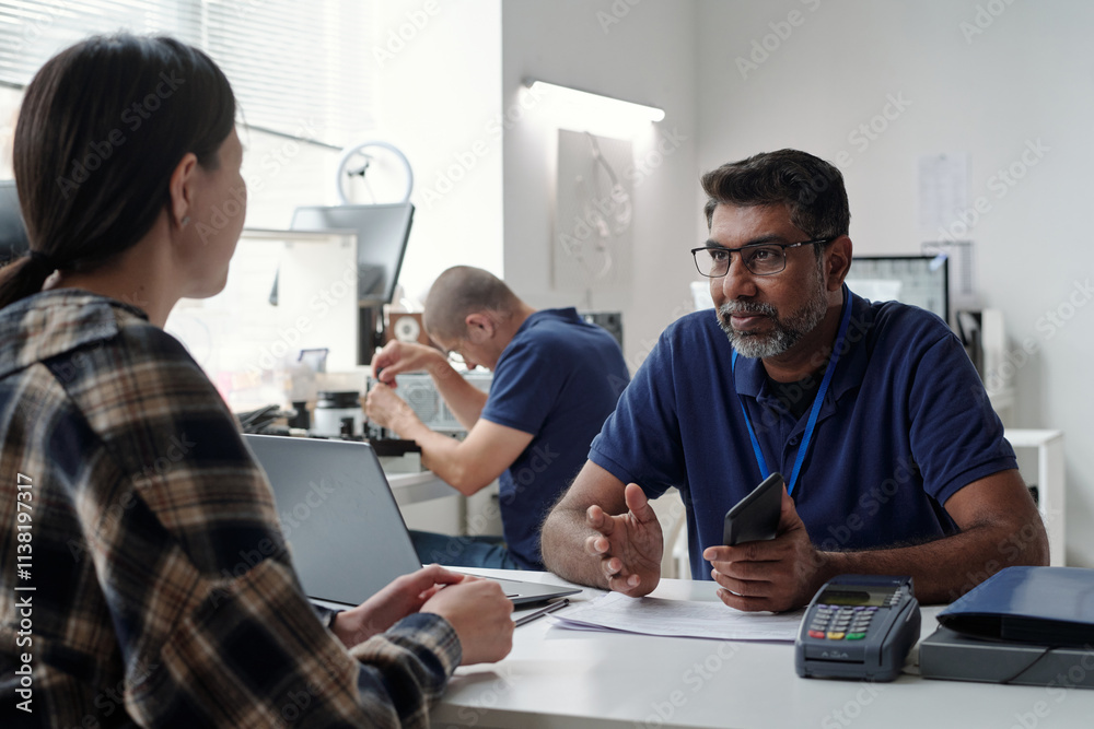 Discussing Work with Colleague in Office Environment Discussing Work with Colleague in Office Environment
