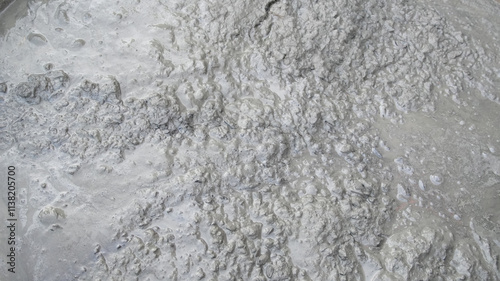 Tableau sur toile Close-up of freshly mixed wet cement showcasing its rough and liquid texture
