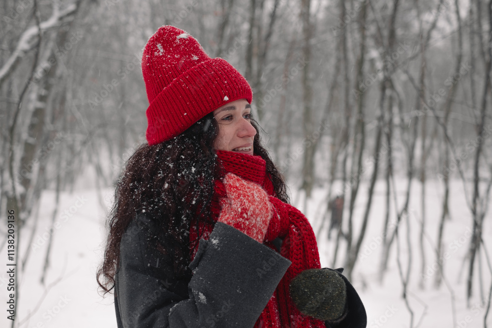 Fototapeta premium Snowy day joy: red hat, scarf, and gloves