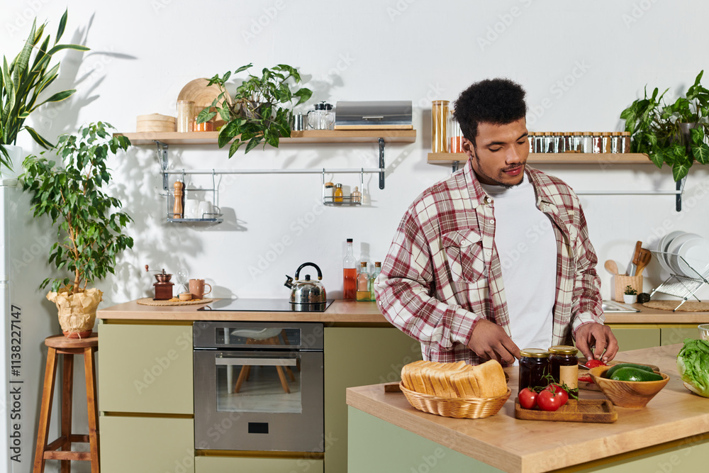 Young man in plaid shirt slices vegetables in a minimalist kitchen filled with plants. Young man in plaid shirt slices vegetables in a minimalist kitchen filled with plants.