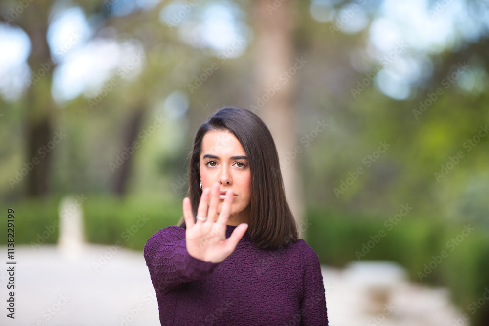 Woman making STOP gesture with hands, stop violence against women, human rights violations, human trafficking. Focus on the face. Advertising campaign. Woman making STOP gesture with hands, stop violence against women, human rights violations, human trafficking. Focus on the face. Advertising campaign.