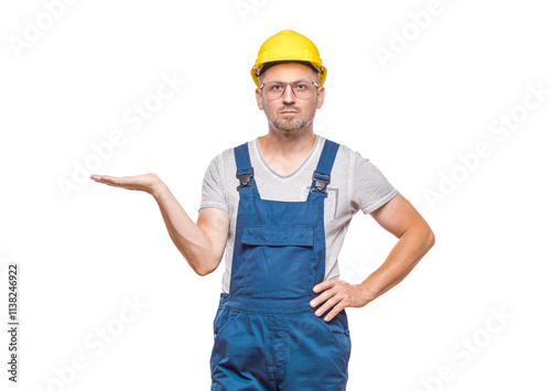 Construction worker holding free advertising space for your product on his palm, isolated on white background. Happy promoter repairman, copy space for text. Craftsman against white wall