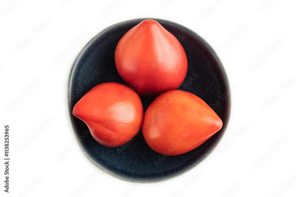 Red Heart shape tomatoes in blue bowl isolated on white. Top view, copy space Red Heart shape tomatoes in blue bowl isolated on white. Top view, copy space
