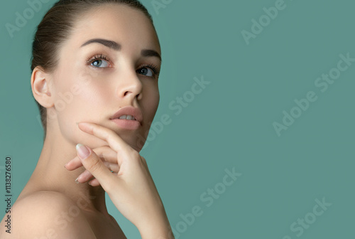 Beautiful young women face with perfect fresh skin and makeup. Portrait of model with make-up, formed eyebrows  and long eyelashes. Beauty and Spa, skincare and wellness. Selective focus.