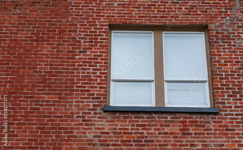 Rustic red brick wall with wooden glass window. .