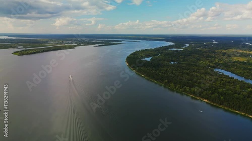 Wallpaper Mural flying over a wide overflowing river and green islands with trees . Top view of the river Torontodigital.ca