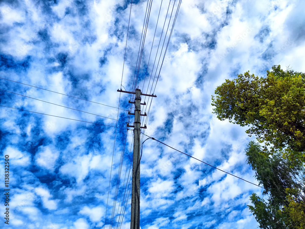 Old pole with wires against the sky. Electric transmission line. Eco-friendly energy Old pole with wires against the sky. Electric transmission line. Eco-friendly energy