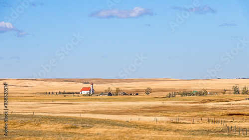 Red roofed rural Saskatchewan church, a landscape of farm fields in Autumn, typical prairieland scene photo