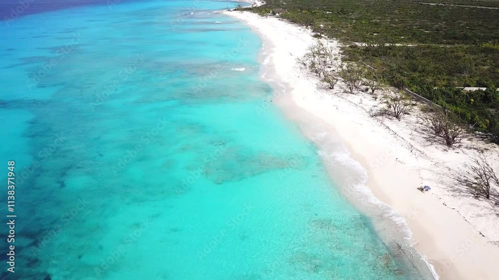 Aerial view of empty beach with clear water and sand on Grand Turk in the Turks and Caicos Islands. Aerial view of empty beach with clear water and sand on Grand Turk in the Turks and Caicos Islands.