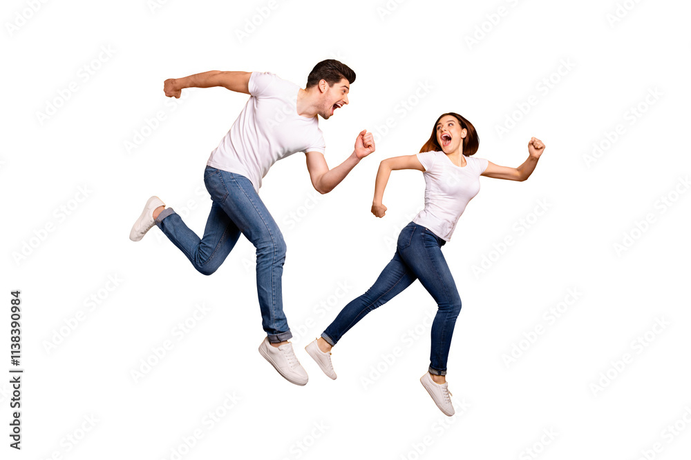 Full length side profile body size photo funky she her he him his pair jumping high hurry shopping raised fists yell scream shout loud wear casual jeans denim white t-shirts isolated yellow background Full length side profile body size photo funky she her he him his pair jumping high hurry shopping raised fists yell scream shout loud wear casual jeans denim white t-shirts isolated yellow background