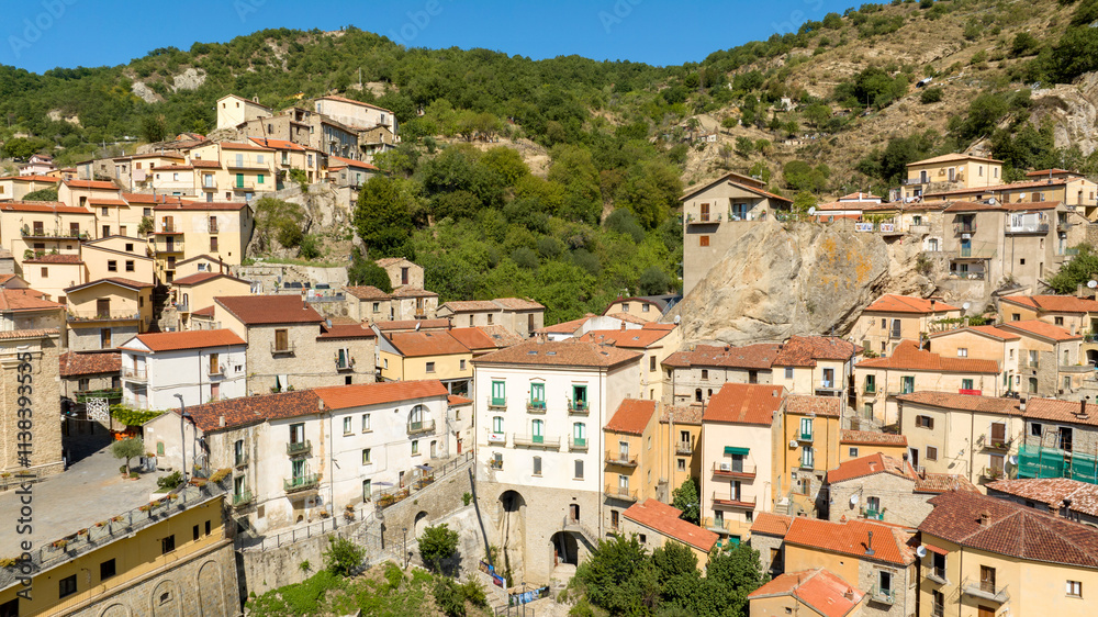 Aerial view of houses and buildings in Castelmezzano, in the province of Potenza, Basilicata, Italy. It is a town built on a mountain in the Dolomiti Lucane park. Aerial view of houses and buildings in Castelmezzano, in the province of Potenza, Basilicata, Italy. It is a town built on a mountain in the Dolomiti Lucane park.